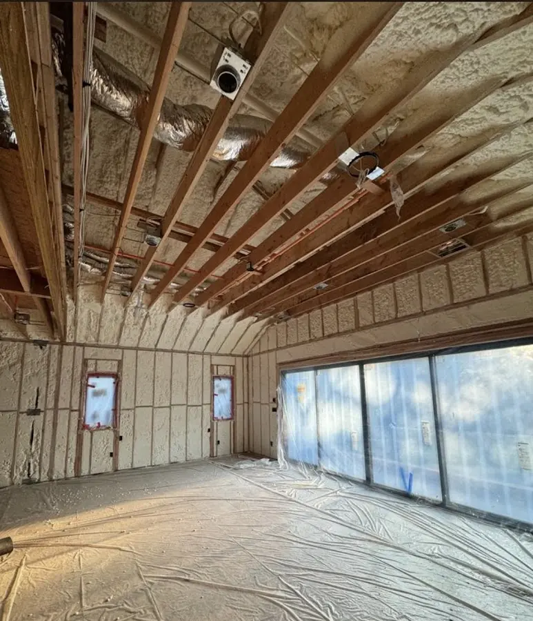 Interior walls and ceiling insulated with spray foam during new construction in Epsom